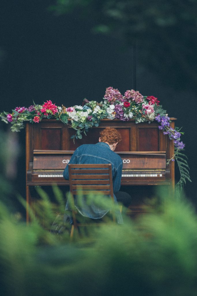 photograph piano in garden man playing